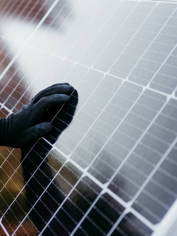 close up view of mature Technician man checking solar panels for self consumption energy. Renewable energies and green energy concept close up view of mature Technician man checking solar panels for self consumption energy. Renewable energies and green energy concept